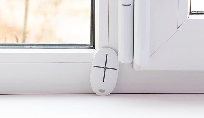 Compact home security sensor installed on window frame