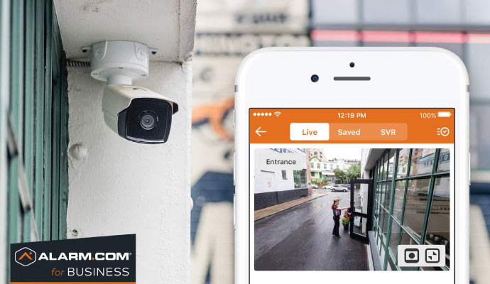 Installed outdoor security camera showing live footage on a mobile device