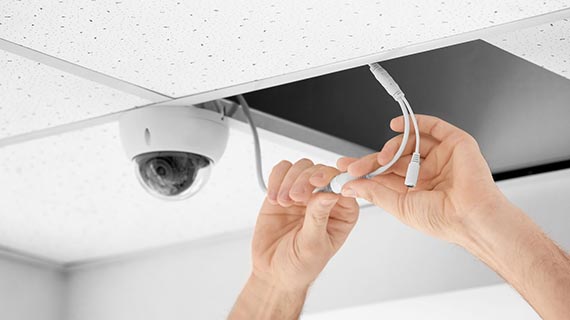 technician installing analog camera