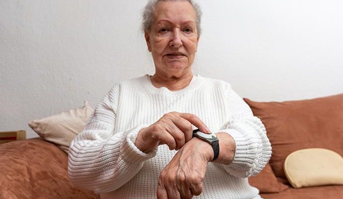 Elderly woman wearing medical pendants